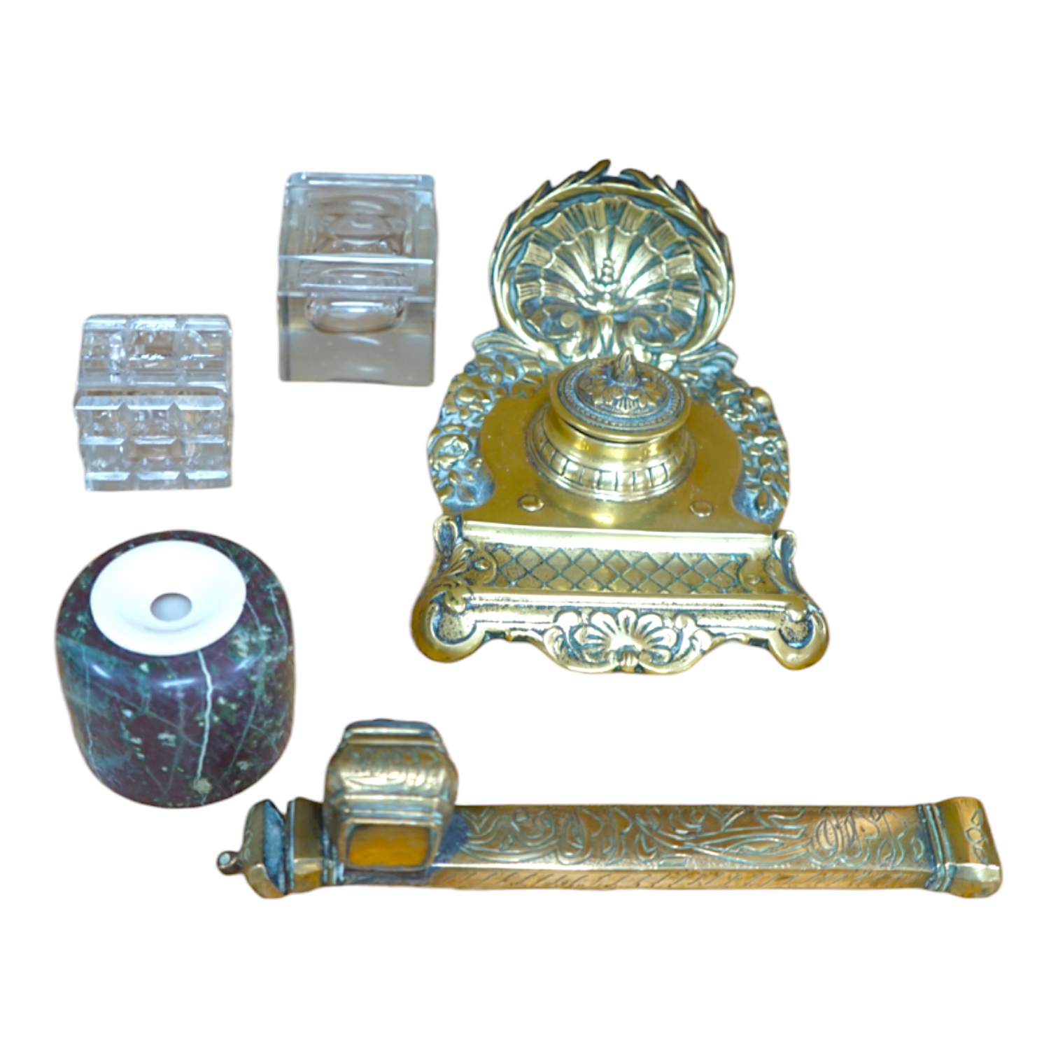 A 19th century Persian brass scribe set, a cast brass inkwell, three other inkwells, largest 24cm in length (5) Condition - poor to fair